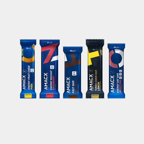 Five energy bars in blue packaging, each displaying the brand name "AMACX" and various flavors such as vanilla, chew bar, and fast bar. The bars are arranged in a fan-like shape on a white background.