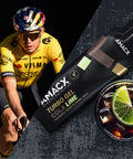 A cyclist wearing a yellow and black outfit and a helmet is riding a bike on the left. On the right, there is a black and green sports gel packet labeled "Turbo Gel | 12-pack" by Amacx with a glass of cola and lime beside it, ideal for energy supply from reliable carbohydrate sources.