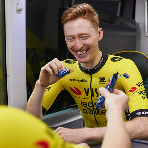 Matteo Jorgenson from Visma Lease cycling team enjoying an Amacx orange-flavored energy fruit chew.
